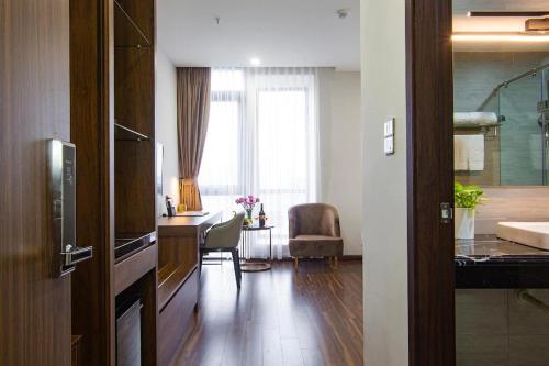 a living room with a kitchen and a dining room at Western Skyline Hotel HN - by BAY LUXURY in Hanoi