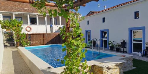 a swimming pool in the backyard of a house at Casa Ciska in Redinha