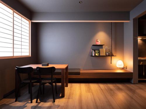 a dining room with a table and chairs and a bench at YANAKA SOW - Cultural Boutique Hotel in Historical area Yanaka - Near Ueno Akiba in Tokyo