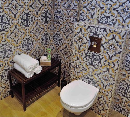 a bathroom with a toilet and a table with towels at Dzuku apartment 11 in Vilnius