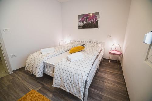a bedroom with two beds and a pink chair at Gotar Apartment with Garden in Kobarid