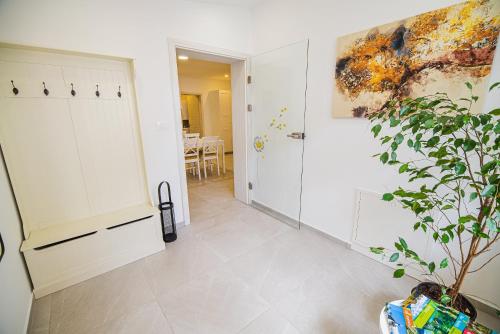 a hallway with a door and a plant on the wall at Gotar Apartment with Garden in Kobarid