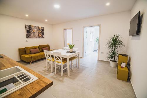 a living room with a table and a couch at Gotar Apartment with Garden in Kobarid