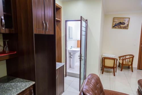 a bathroom with a sink and a toilet in a room at Olympic Hotel in Kigali