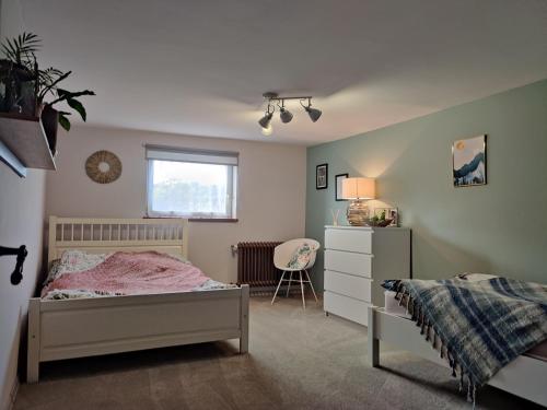 a bedroom with a bed and a dresser and a window at Pod Wieżą u Kory in Siedlęcin