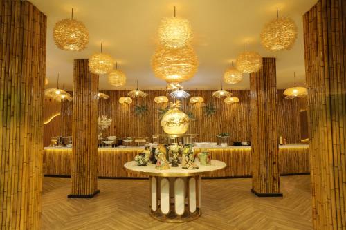 a room with many chandeliers and a table at Pleiku Hotel by Gia Lai Tourist in Pleiku