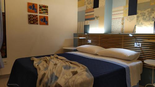 a bedroom with a bed with two pillows on it at Atelier B&B in Ascoli Piceno