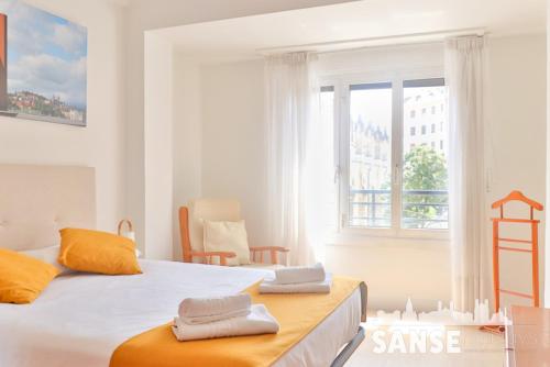 a bedroom with a large bed with towels on it at Apartamento Colón by SanSe Holidays in San Sebastián