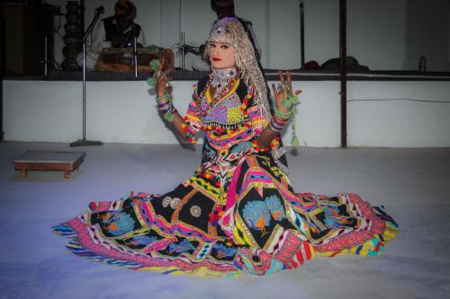 a woman is sitting on the floor in a dress at NK Desert Camp Jaisalmer in Sām