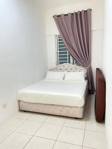 a bed in a white room with a window at Biella Homestay Apartment for Muslim in Tanah Rata