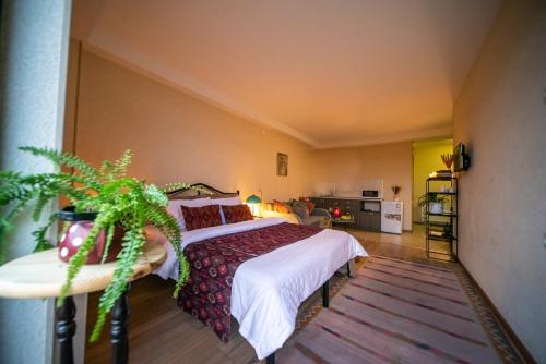 a bedroom with a large bed with white sheets and red pillows at Chalet Papa Basili in Gudauri