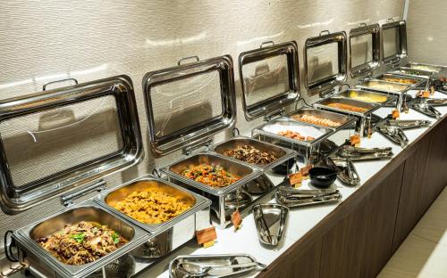 a buffet line with many trays of food at Spring Rhapsody Hotel in Taichung