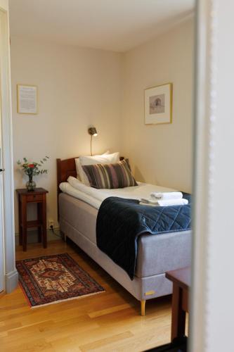 a bedroom with a bed in a room with a table at Munkedals Herrgård in Munkedal