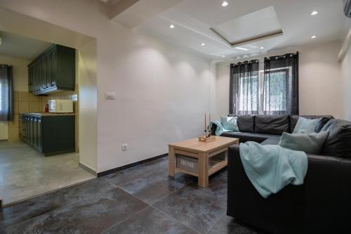 a living room with a couch and a table at Villa Erwin with heated pool in Imotski