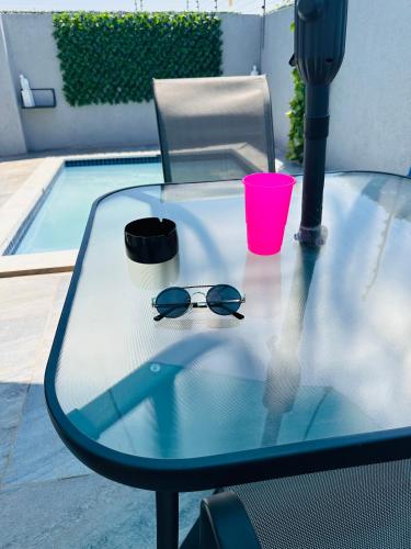 a table with a pair of glasses and a cup on it at The Pool_deck apartment in Lebowakgomo