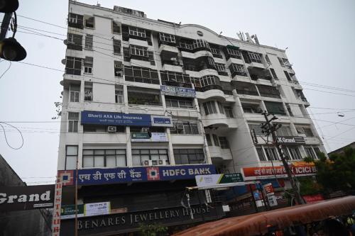 a tall white building with signs on it at Narayan Palace- Luxury Homestay in Varanasi