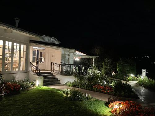 a house lit up at night with a garden at Gateway Coonoor in Coonoor