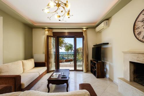 a living room with a couch and a fireplace at Your Private Luxury Villa Mahin, Pool, Sea view, Rethymno in Kiriánna