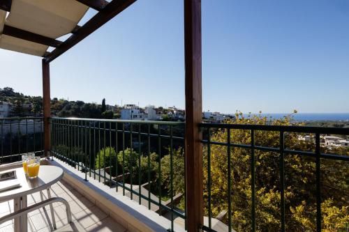 a balcony with a table and a view at Your Private Luxury Villa Mahin, Pool, Sea view, Rethymno in Kiriánna
