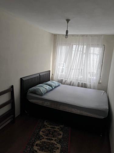 a bed sitting in a room with a window at Fatih Eco 3 Apart in Istanbul