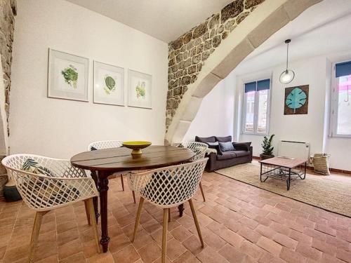 un salon avec une table et des chaises en bois dans l'établissement Joli studio au coeur de Grasse - Parking inclus, à Grasse