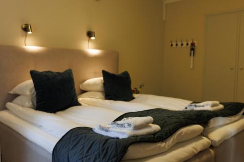 two beds in a room with towels on them at Munkedals Herrgård in Munkedal