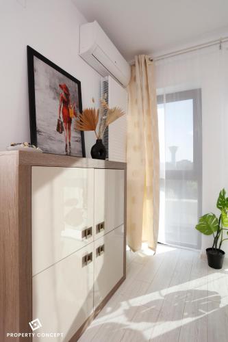a white cabinet in a room with a window at Park Residence Concept Studio 7 in Bucharest