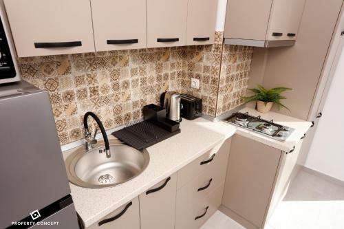 a small kitchen with a sink and a microwave at Park Residence Concept Studio 7 in Bucharest