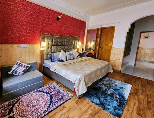 a bedroom with a bed and a red wall at The Bougainvillea, Mcleodganj in Dharamshala