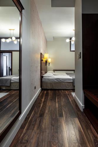 a room with two beds and a mirror at Hotel Galicja Superior Wellness & Spa in Oświęcim