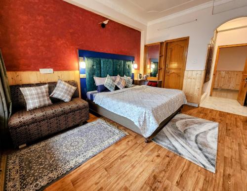 a bedroom with a bed and a couch in it at The Bougainvillea, Mcleodganj in Dharamshala