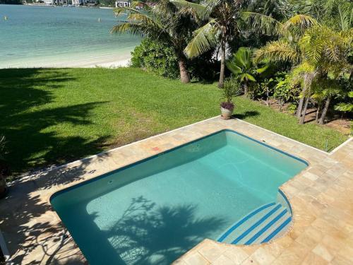 a swimming pool with a view of the beach at Paradise Villa Eden Island in Mahe