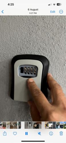 a person holding a remote control in their hand at Iwan Ila Homestay in Batang Kali