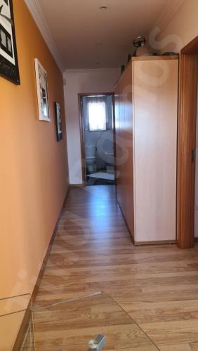 a room with a hallway with a door and wooden floors at Casa Ramos in Póvoa de Varzim