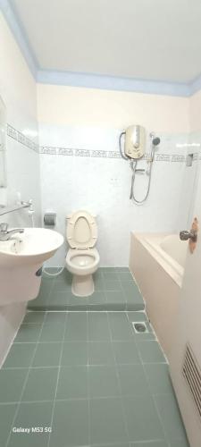 a white bathroom with a toilet and a sink at Nhật Bình 2 in Ho Chi Minh City