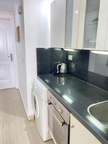a kitchen with a sink and a washing machine at شاليه في بورتو مارينا الساحل الشمالي العلمين شاليه دور 9 in El Alamein