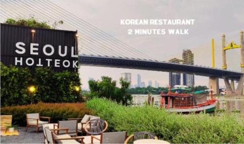a sign for a hotel with a boat in a river at The View Residence in Bangkok
