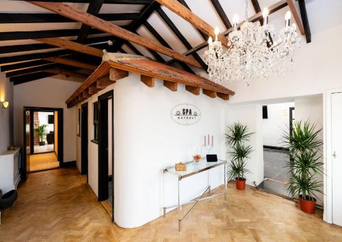 a room with a white wall and a chandelier at Spa Retreat in Portsmouth