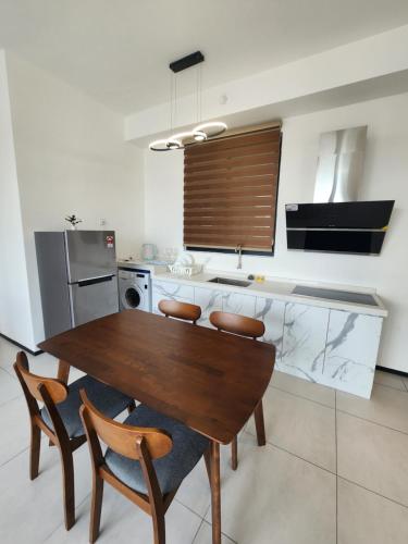 a kitchen with a wooden table and four chairs at Urban Suite - George Town in Jelutong