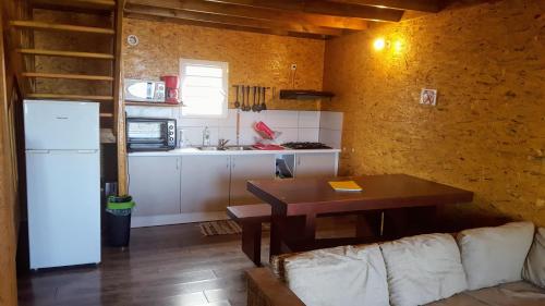 a kitchen with a couch and a table in a room at Chalet Floricia974, meublé de tourisme in Saint-Paul