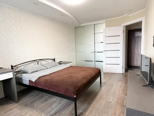 - une chambre avec un lit, un bureau et une télévision dans l'établissement 0147 New flat near airport Zhulyany Sofievskaya Borshchagovka, à Kiev