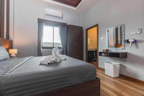 a bedroom with a large bed and a television at N&D Poolvilla in Ao Nang Beach