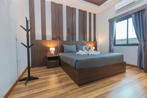 a bedroom with a bed with two towels on it at N&D Poolvilla in Ao Nang Beach