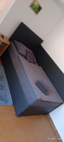 a black box with a bed in a room at Penzion Forest in Rozvadov
