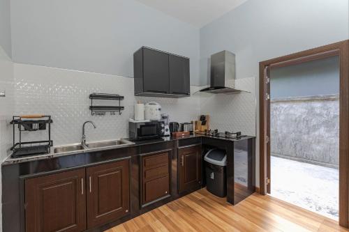 a kitchen with a sink and a counter top at N&D Poolvilla in Ao Nang Beach