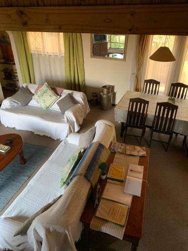 a living room with two beds and a table at Manwood Lodge in Rosetta