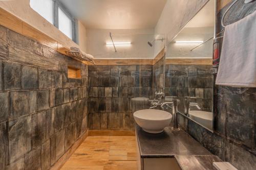 a bathroom with a sink and a toilet and a tub at Tree of Life Birdsong Chalets , Dharamshala in Dharamshala