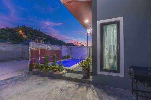 a house with a backyard with a swimming pool at N&D Poolvilla in Ao Nang Beach