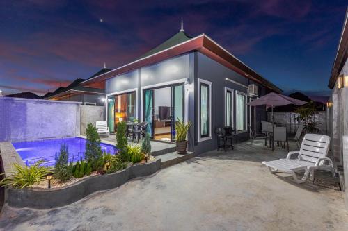a house with a swimming pool in front of it at N&D Poolvilla in Ao Nang Beach
