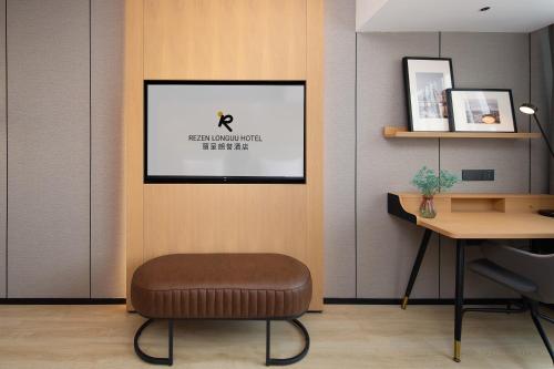 a chair in a room with a picture on the wall at Langham Honor International Hotel Canton Fair Complex Kecun Metro Station Branch - Free Shuttle Bus to Canton Fair Complex During Canton Fair Period & Free Deliver Service to Guangzhou Baiyun International Airport in Guangzhou